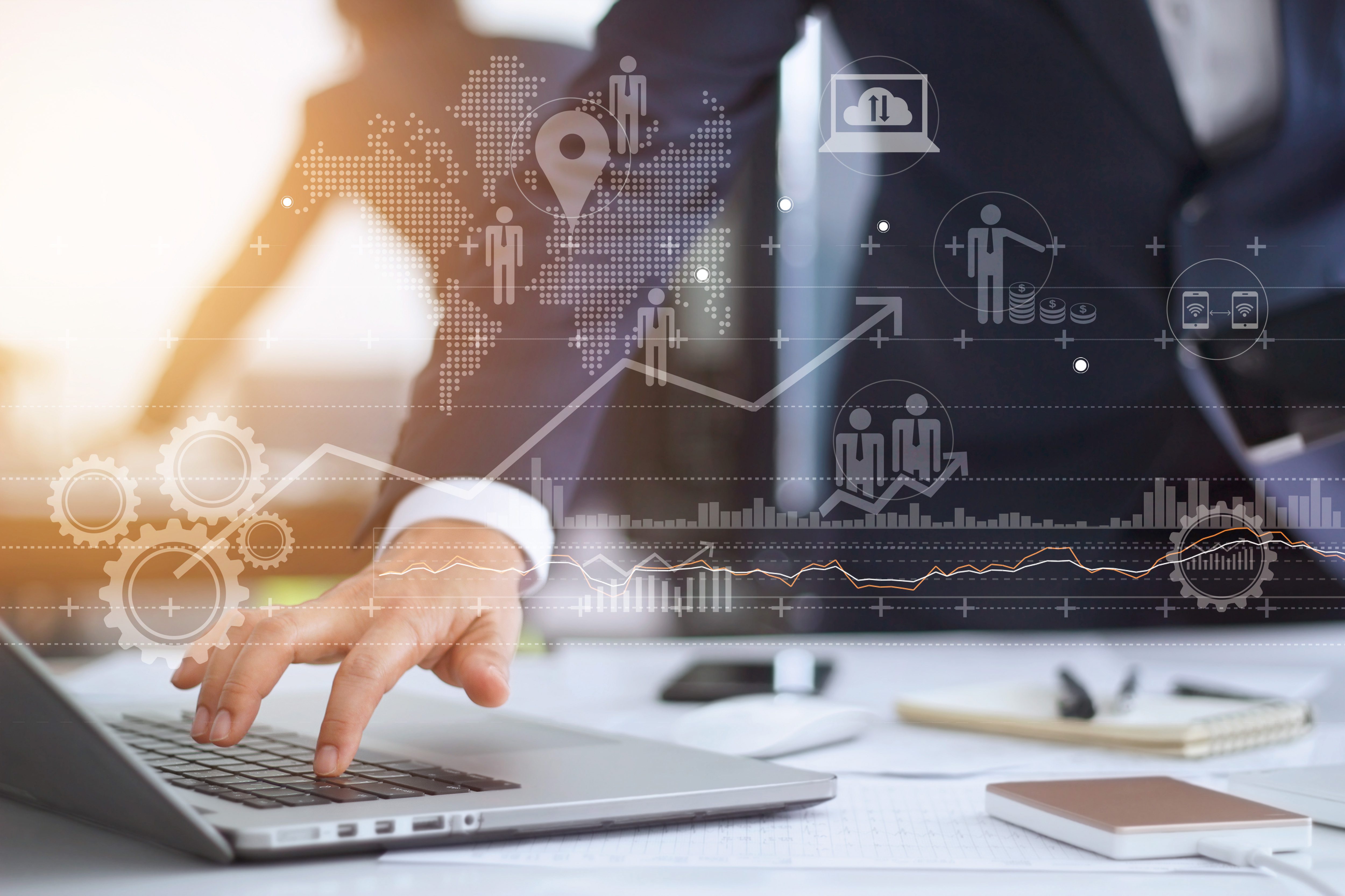 A businessman is typing on his laptop with a background