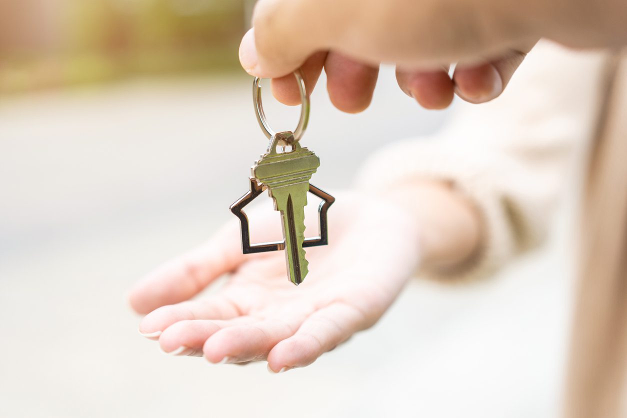 Parents giving child the key to their new property