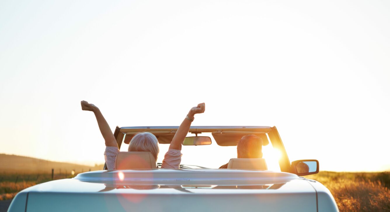 Couple in a car excited about their retirement planning goals