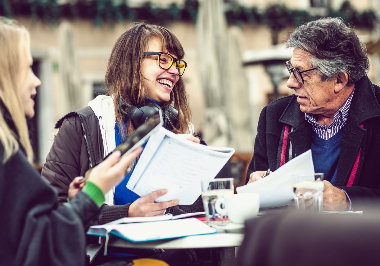 Family members discussing finances at a coffee shop