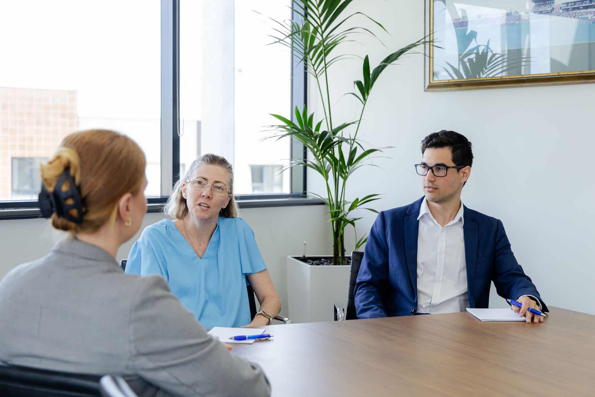 Three people in a meeting